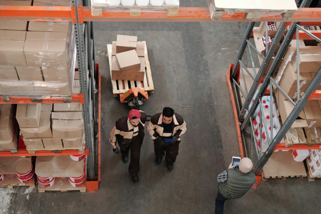 pexels photo 4481260 4481260 High angle view of warehouse workers organizing and preparing shipments with boxes and pallets.